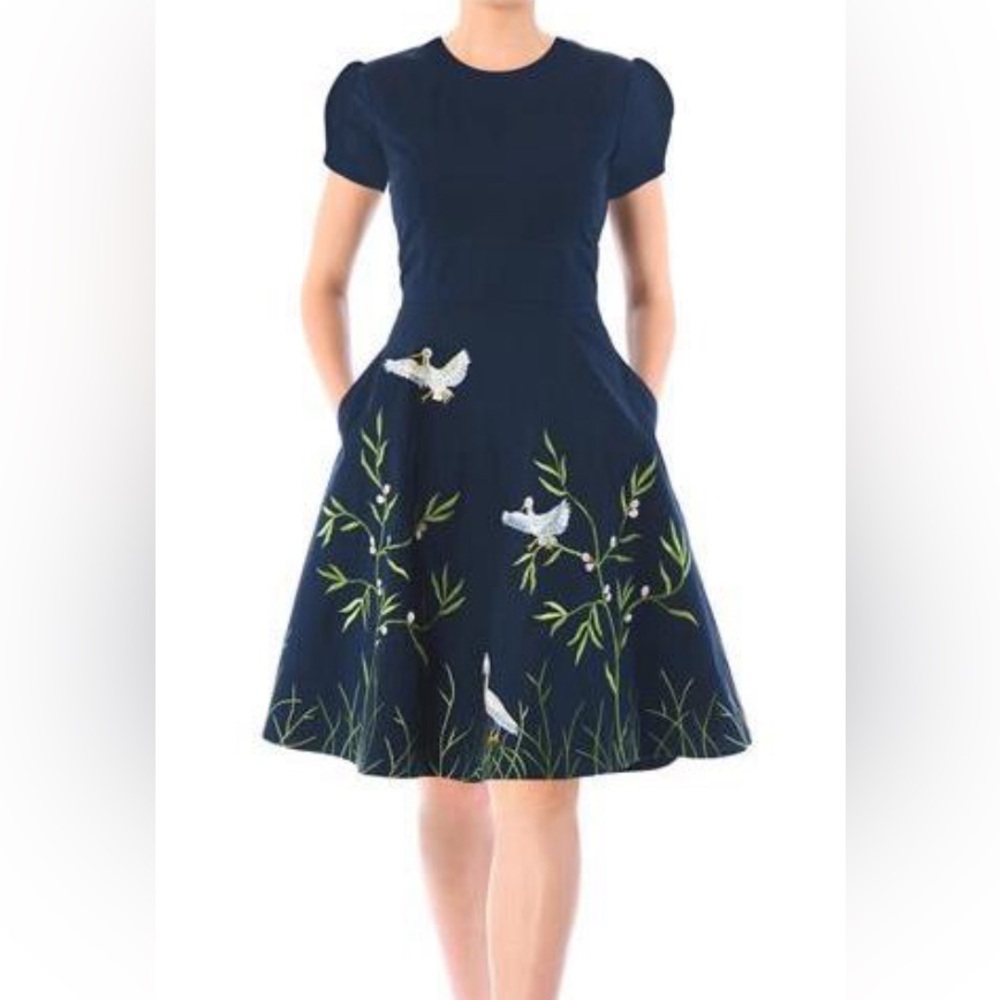 Poplin dress with embroidered birds across the bottom of the dress and the back